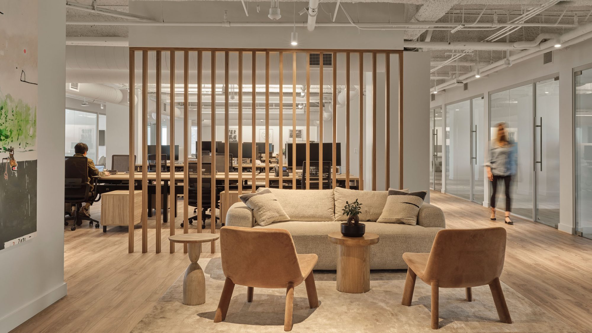 Office design by M Moser in Los Angeles for GMB Azoff Company featuring hospitality-driven design elements, comforting furniture and bright, collaborative spaces throughout the open-plan office.