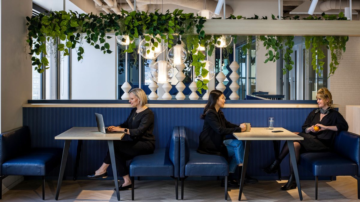 people working at low booth seating area