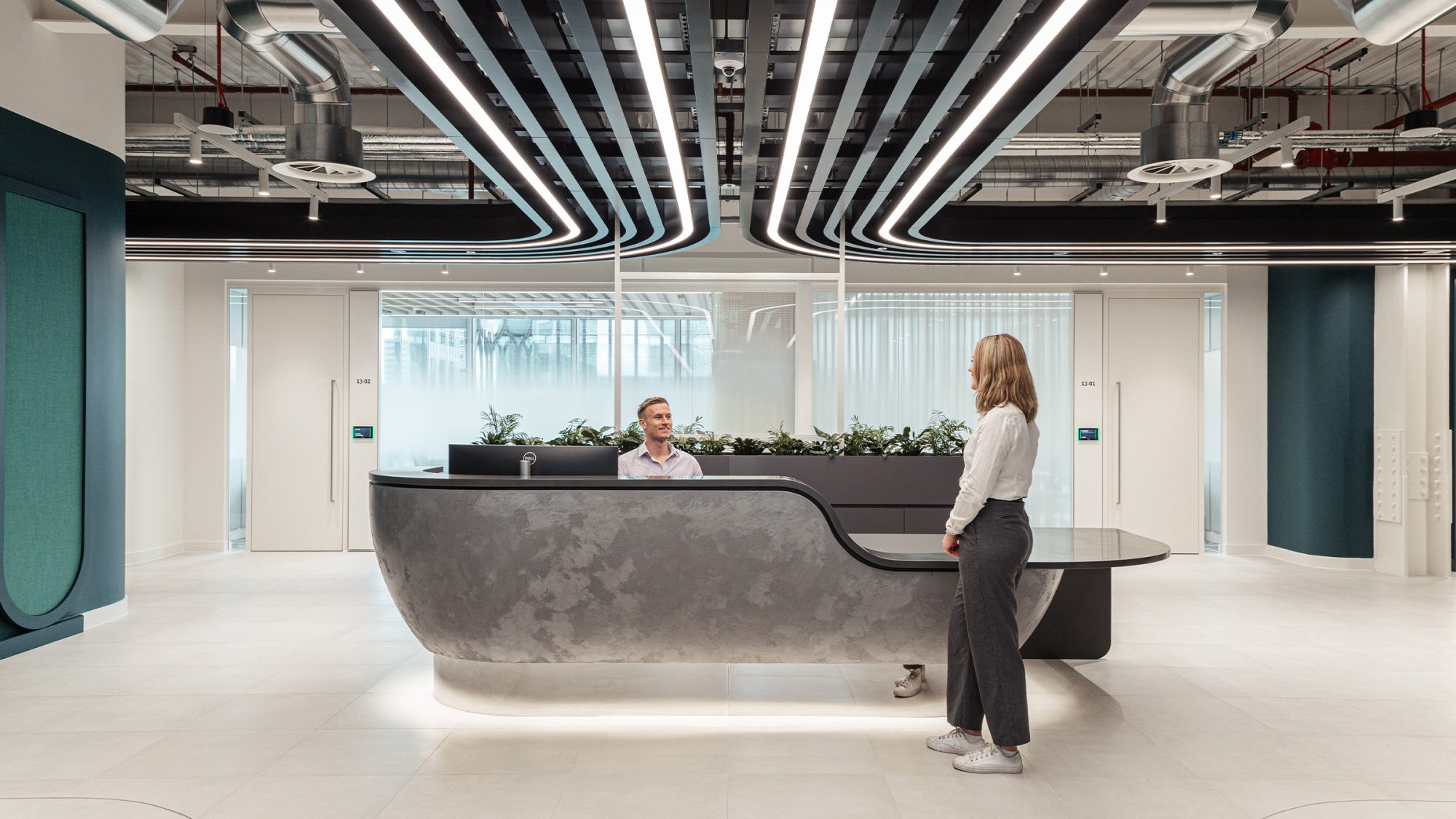 a visitor greeted at a reception desk