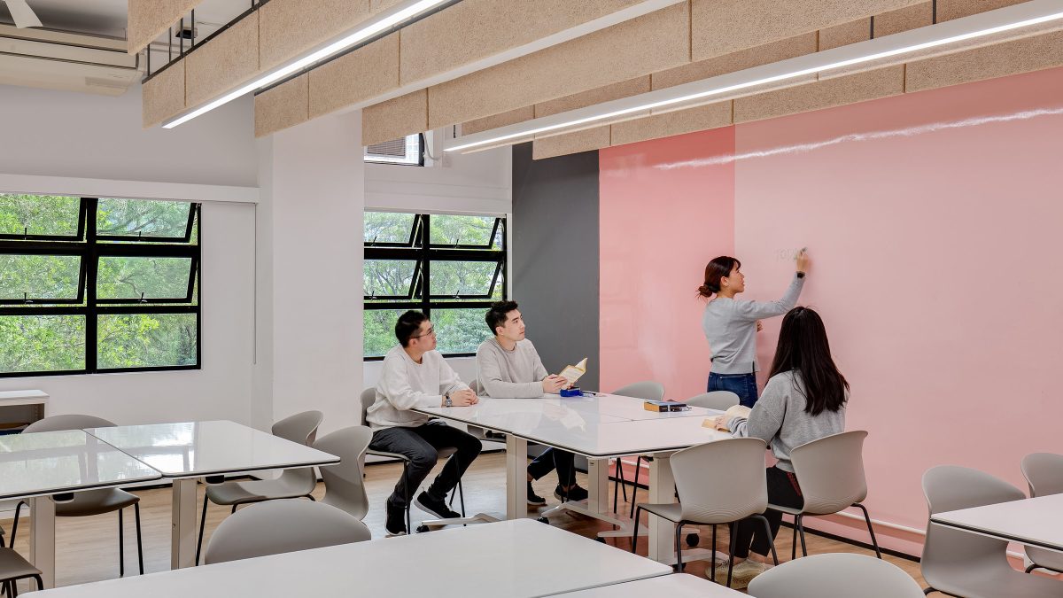 students writing on walls in classroom