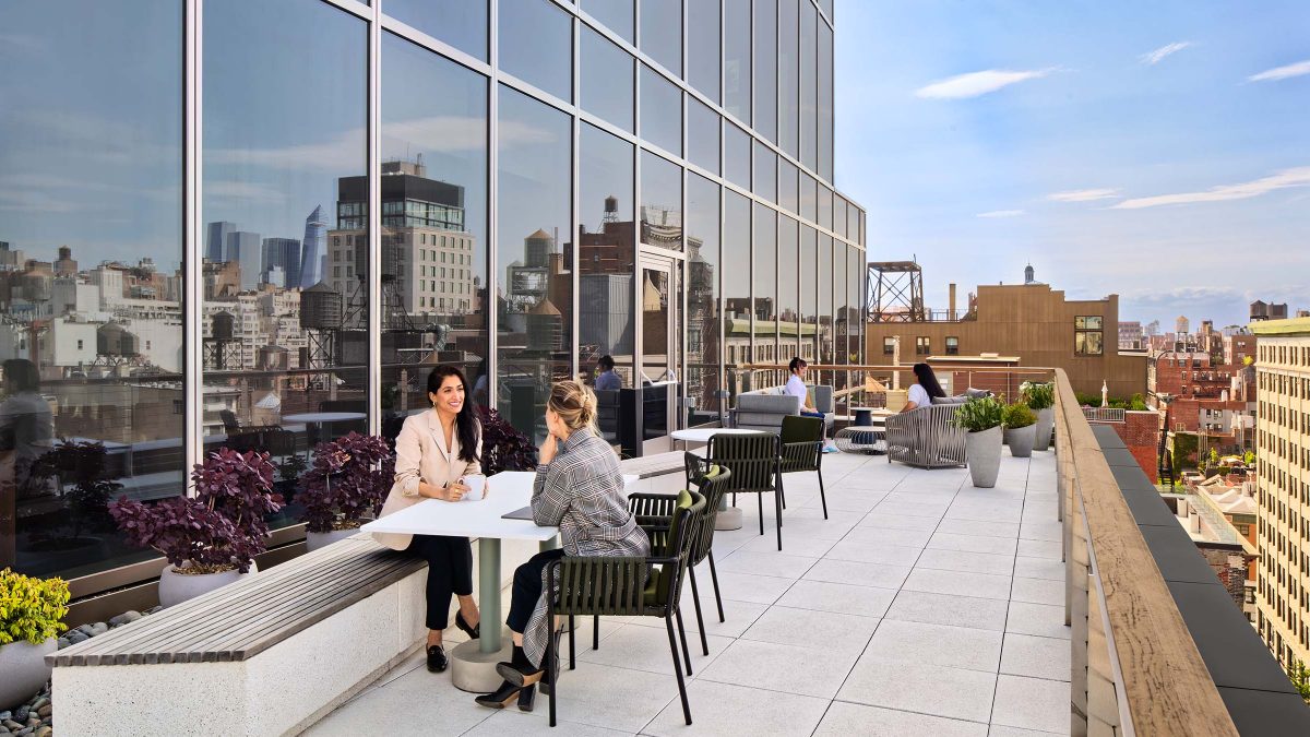 An outdoor patio area for employee breaks offering various seating options and beautiful views of downtown New York.