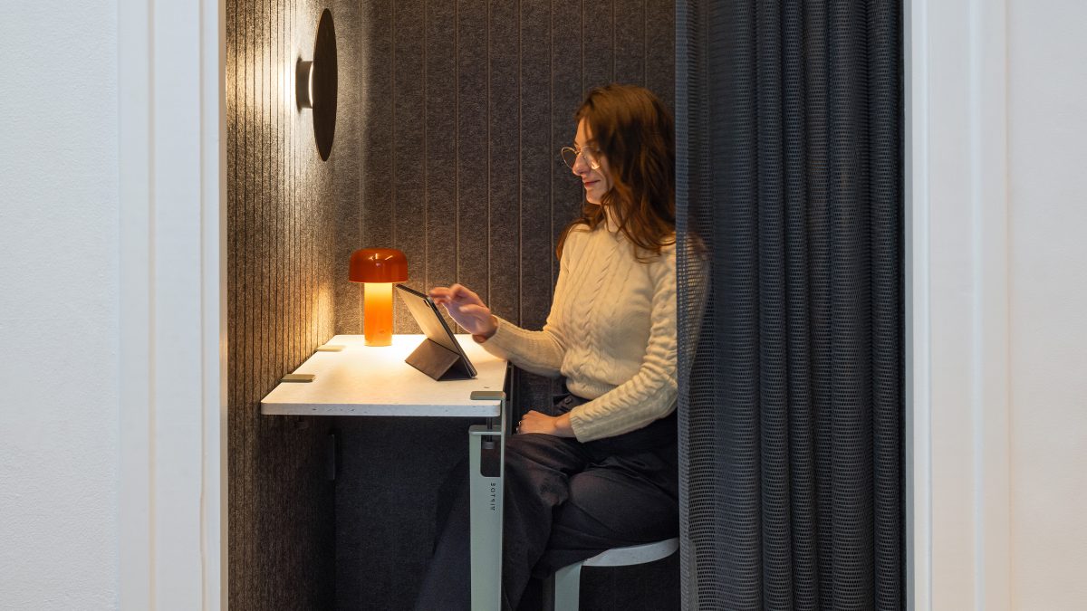 person-in-quiet-nook-reading-a-tablet-at-M-Moser-Amsterdam-studio