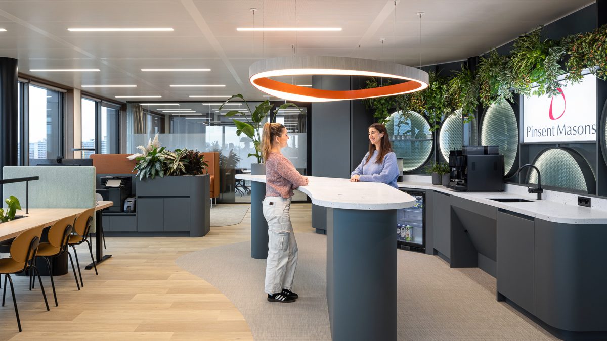 people-talking-at-a-raised-table-in-pinsent-masons-amsterdam-office
