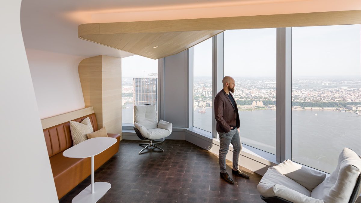 man admiring view in casual area in office design for DNB