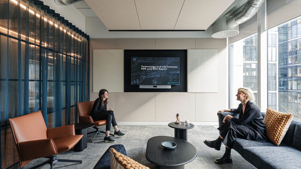 two-people-in-an-informal-meeting-room-at-wilson-sonsini-london-office