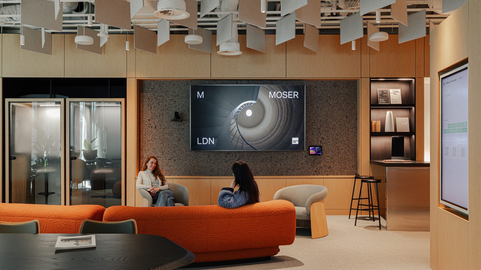 two-people-chatting-in-hospitality-hub-at-m-moser-london-studio
