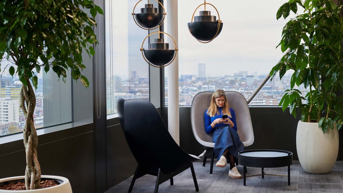 reading-nook-woman-with-phone-financial-workplace-design