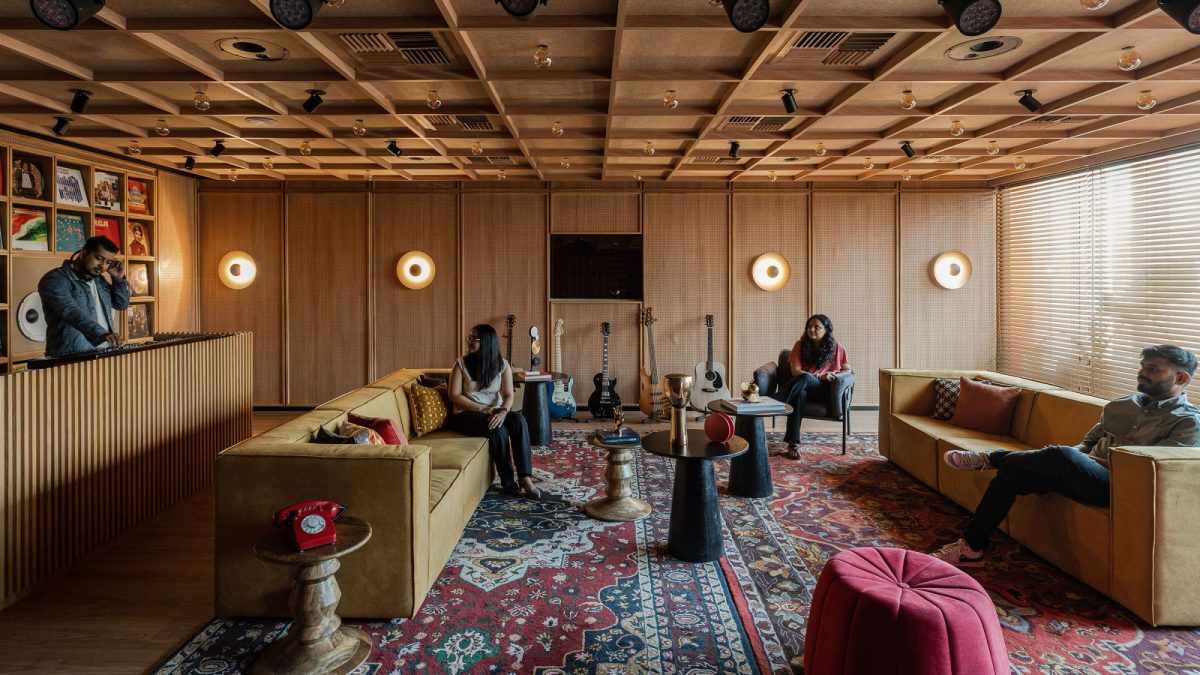 Employees in office lounge space with musical instruments