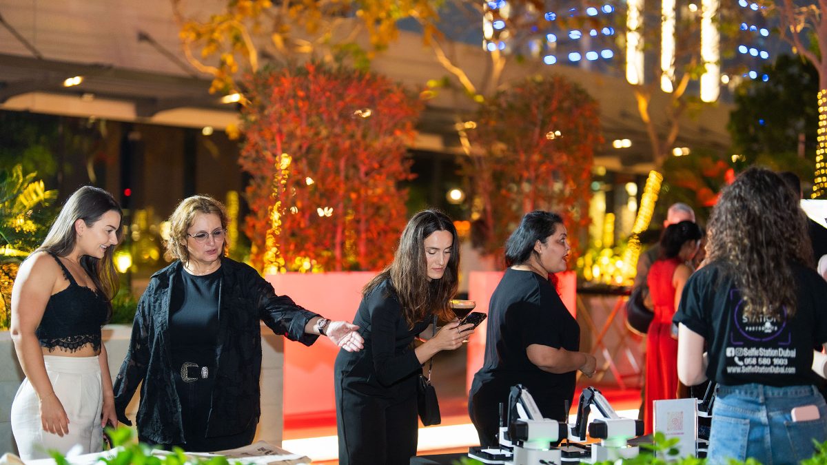 M Moser Dubai party guests interacting with the Draw me Bot