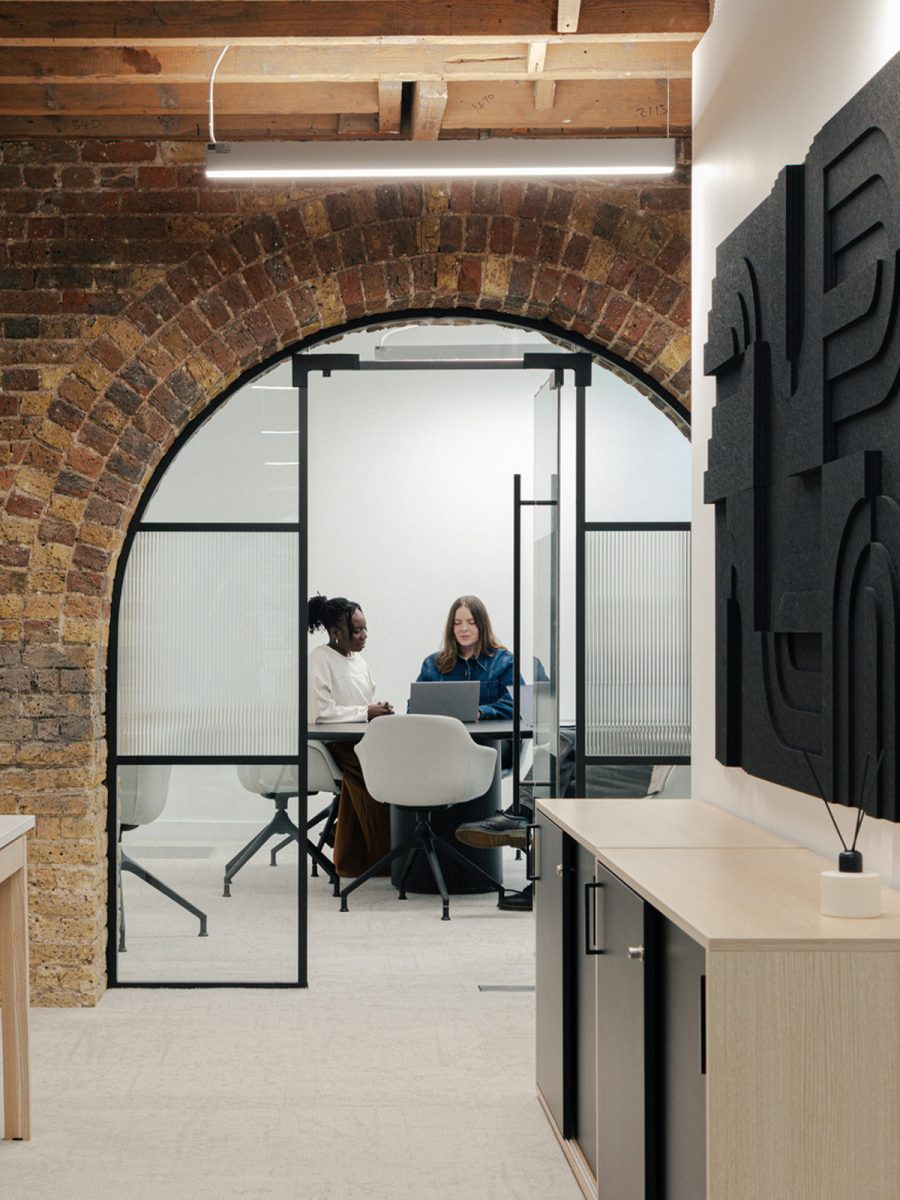 two-people-working-in-arched-door-meeting-room-within-knotel-tenant-ready-space