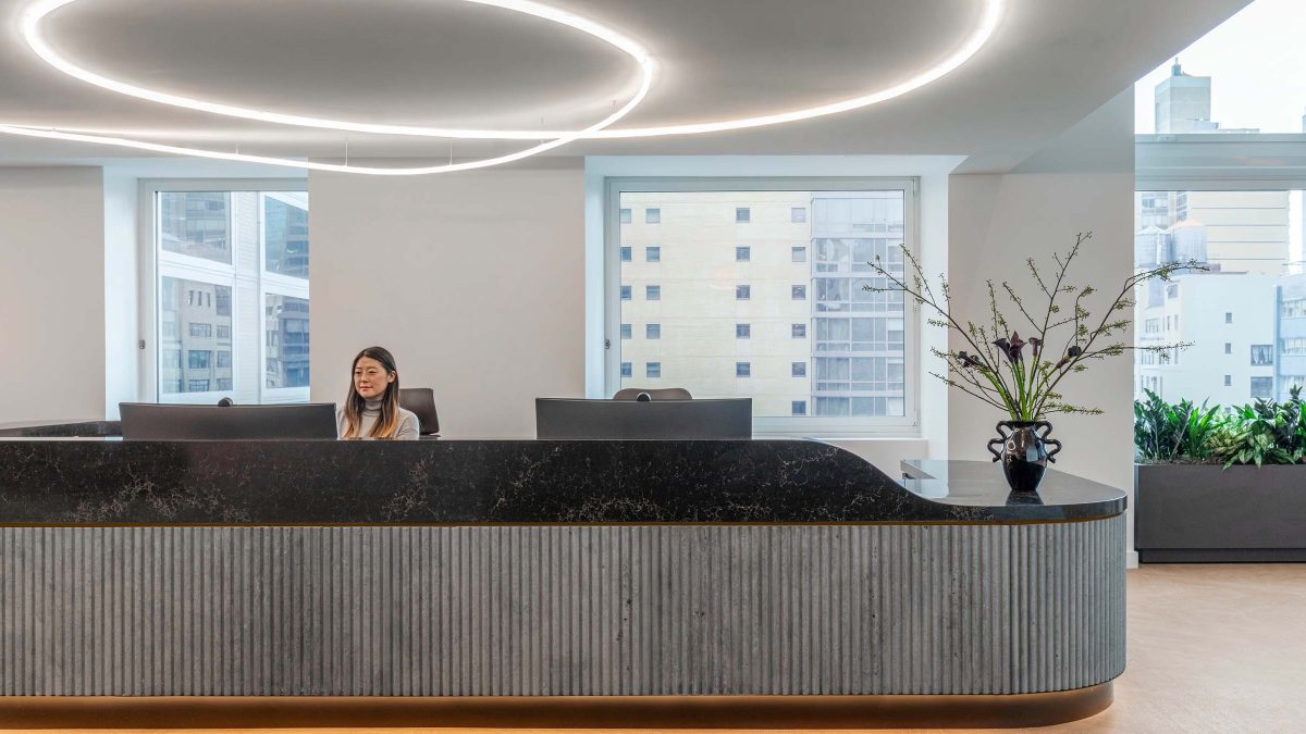curved-reception-desk-design-woman-sitting