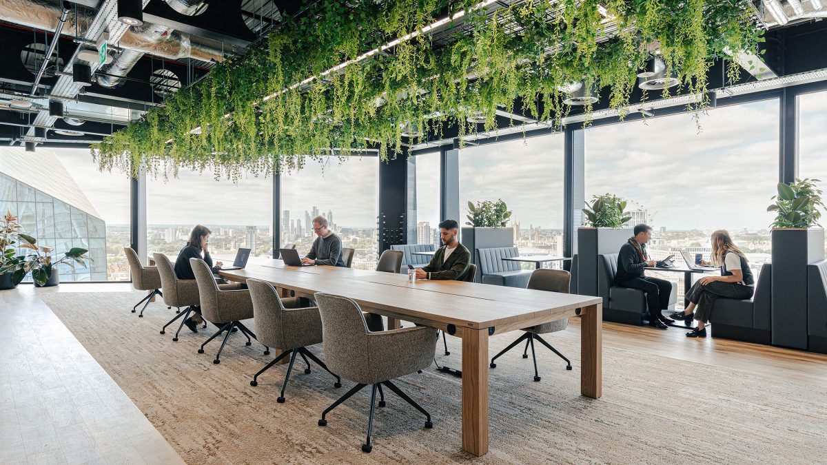 people-working-at-large-communal-table-at-wipro-london-office