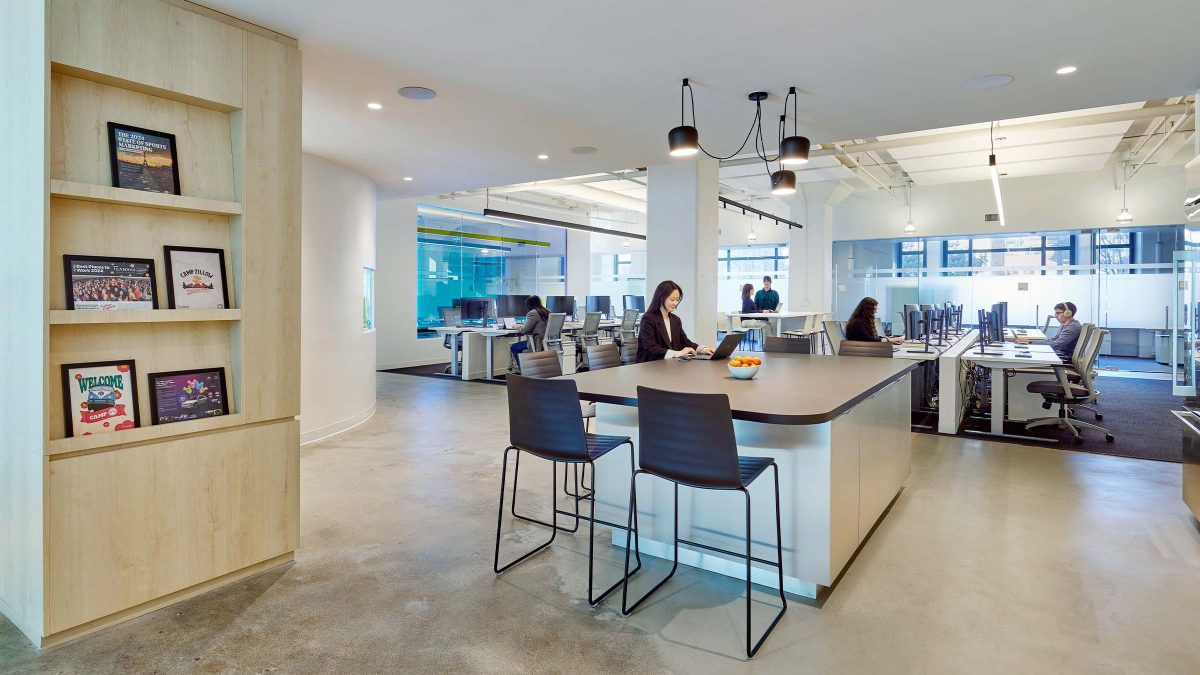 open-collaboration-space-bookshelf-people-working
